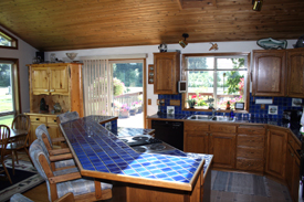 Island Kitchen with Oak Cabinets and Tile Counters