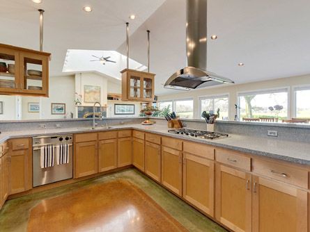 Spacious kitchen with gas range and stainless hood
